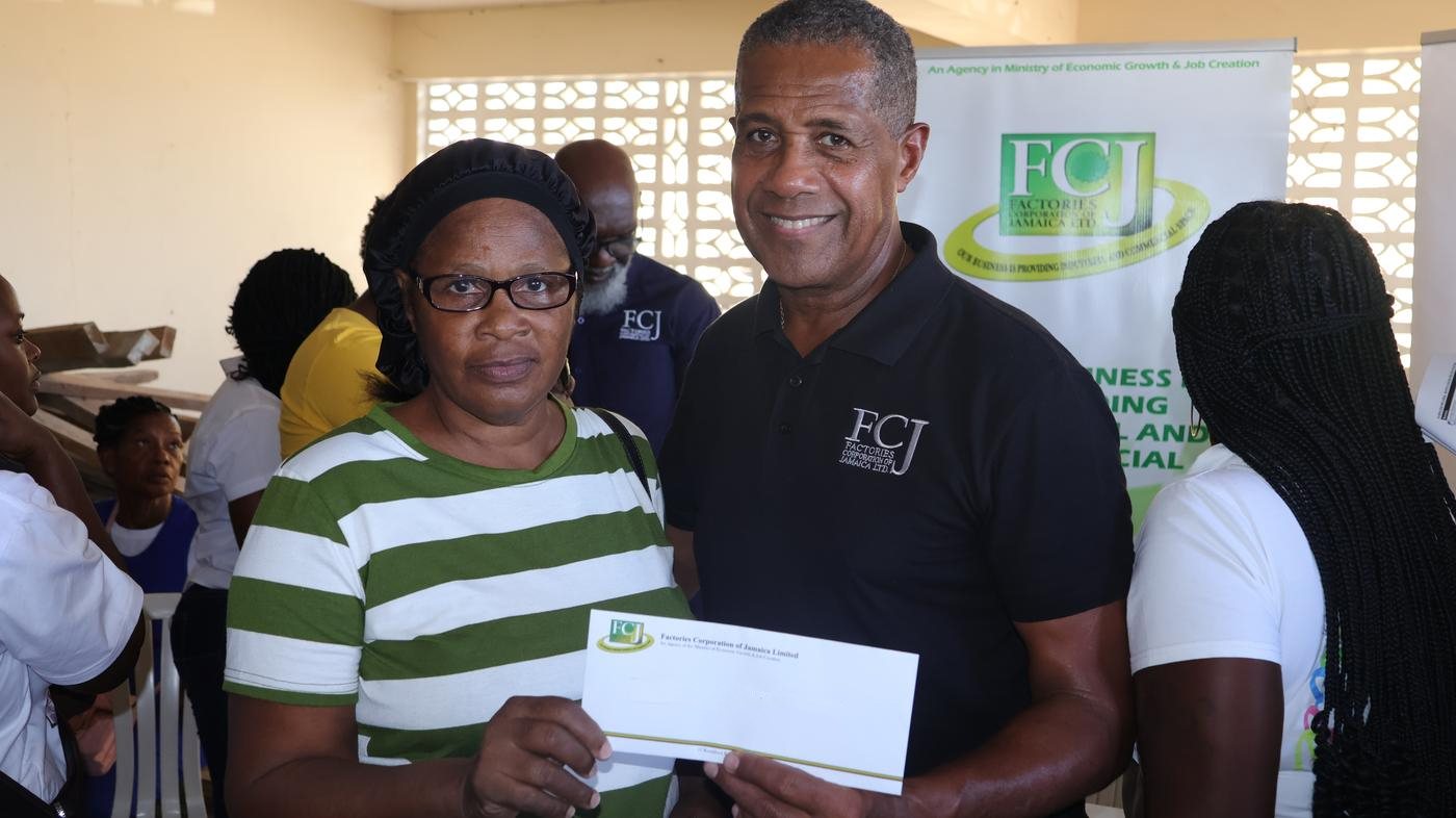FCJ chairman presenting a hurricane recovery grant in Whitehouse, Westmoreland